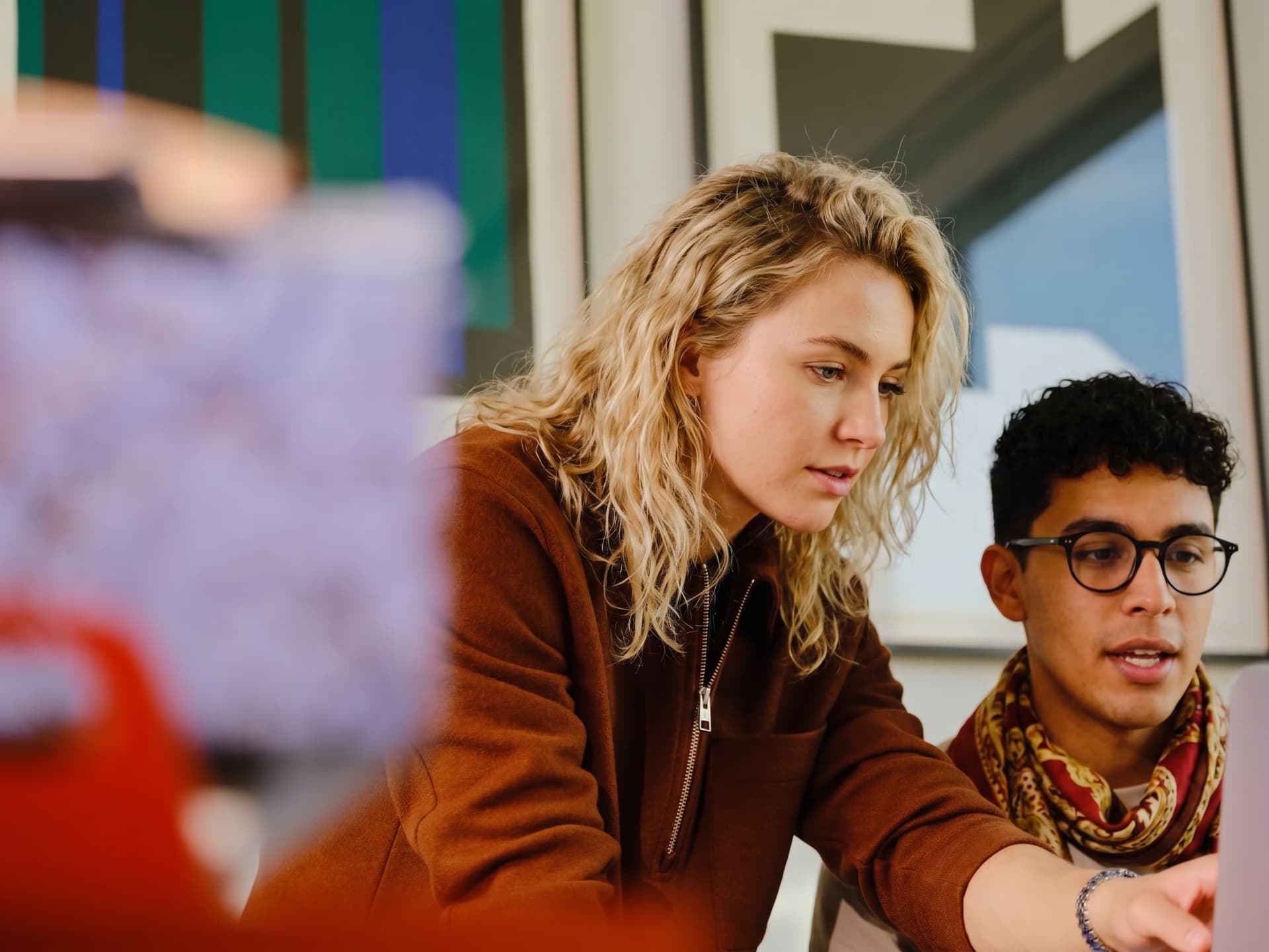 Two people analysing data together on a screen